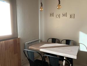 a table and chairs in a room with a table at CyclosApart in Esquel