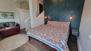 a bedroom with a bed with a blue wall at Hand Hotel in Fairplay