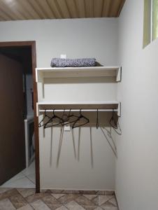 a shelf in the corner of a room at Pousada Maria Rosa in Blumenau