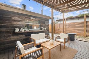a patio with chairs and a table and a grill at Little Cottage in Miami