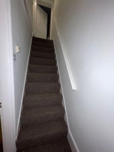 a staircase in a house with a stair case at Modern 2 Bed in the heart of Maidstone in Kent