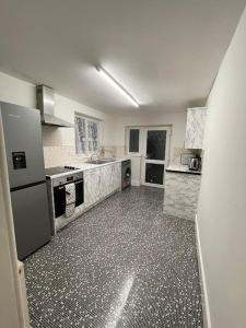 a large white kitchen with a large floor at Modern 2 Bed in the heart of Maidstone in Kent