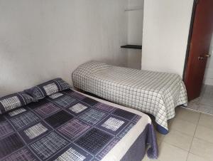 Un pat sau paturi într-o cameră la Hotel Brisas del Quisco