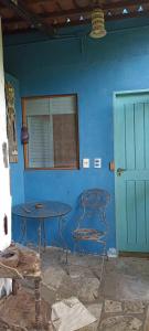 a blue room with a table and a blue wall at Casa Furtacor in João Pessoa