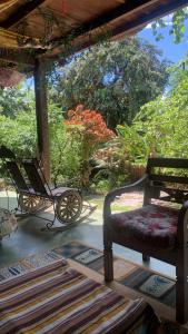 a carriage sitting on a porch with a rug at Casa Furtacor in João Pessoa