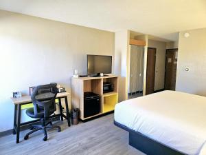 a hotel room with a bed and a desk with a computer at Days Inn by Wyndham Rolla in Rolla
