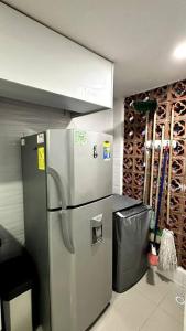 a stainless steel refrigerator in a kitchen with a wine cellar at Apartamento en segundo piso Zafiro C, Valle del Lili. in Cali