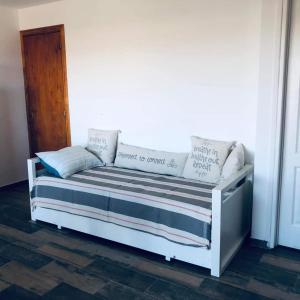 ein weißes Bett mit Kissen auf dem Zimmer in der Unterkunft Sur Bonito in Río Grande