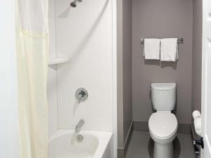 a bathroom with a toilet and a tub and a sink at Motel 6-Morro Bay, CA in Morro Bay