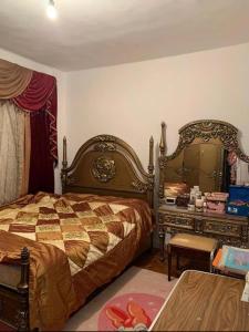 a bedroom with a bed and a dresser at عباس العقاد in Cairo
