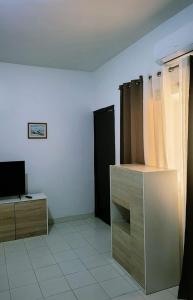 a living room with a tv and a dresser at Bella casa in Dakar