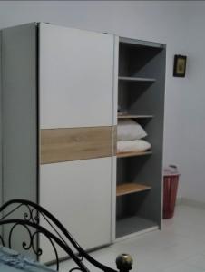 a white cabinet with wooden shelves in a room at Bella casa in Dakar