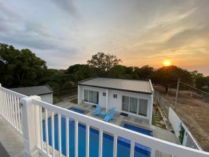 uma vista a partir da varanda de uma casa com piscina em Mangroves & Sandbar Private Resort em Calatagan
