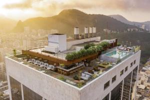a building with a pool on top of it at Hilton Copacabana Rio de Janeiro in Rio de Janeiro