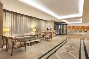 a living room with a couch and chairs at Hilton Copacabana Rio de Janeiro in Rio de Janeiro