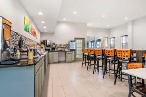 a fast food restaurant with orange bar stools at Quality Inn & Conference Center Panama City in Panama City
