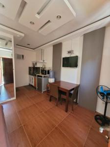 a living room with a table and a kitchen at La Belle Staycation in Puerto Princesa City +9 photos