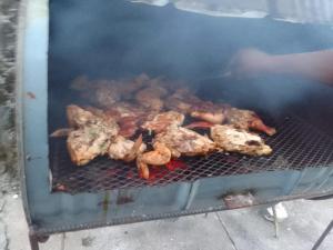 a group of chickens cooking on a grill at Belle Air Seaview ( 2 Bdrm -2 Bath) in Runaway Bay
