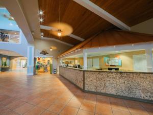 a lobby with a bar in the middle of a building at Holiday Inn Club Vacations Cape Canaveral Beach Resort in Cape Canaveral