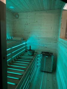 an empty sauna with blue lights on the inside at Kajaki wino i śpiew - domek z sauną w otoczeniu lasów i sąsiedztwie zalewu in Zakrzówek Szlachecki