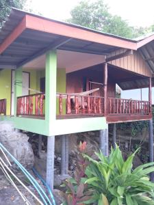 a house with a wrap around porch and balcony at Easy Life Bungalows in Haad Yao