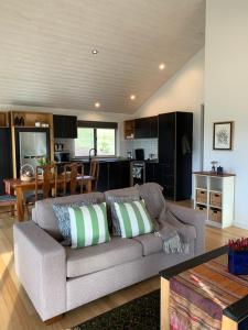 a living room with a couch and a kitchen at Sundays in Middleton
