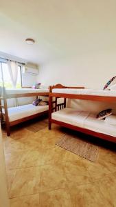a room with three bunk beds and a window at LIVE APARTMENTS Cartagena in Cartagena de Indias