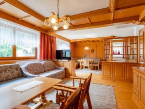 a living room with a couch and a table at Chalet Holdernach in Kappl