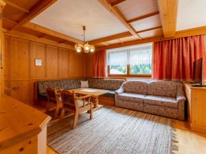 a living room with a couch and a table at Chalet Holdernach in Kappl