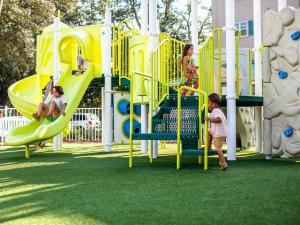 a group of children playing on a playground at Holiday Inn Club Vacations South Beach Resort in Myrtle Beach