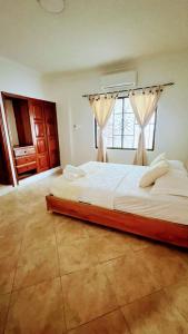 a bedroom with a large bed with a window at LIVE APARTMENTS Cartagena in Cartagena de Indias