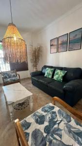 a living room with a black couch and a table at LIVE APARTMENTS Cartagena in Cartagena de Indias