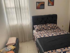 1 dormitorio con 1 cama con cabecero negro en Pousada Axé, en Salvador