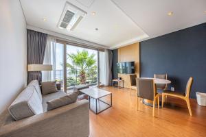 a living room with a couch and a table at The Grand Sumorum in Seogwipo