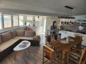 a living room with a couch and a table at Secluded fisherman's cottage Cove Prnjica, Pag - 12620 in Kolan