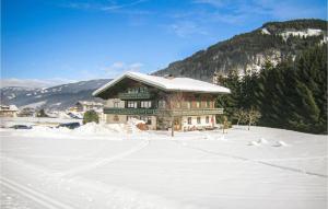 a large building in the snow in front of a mountain at Amazing Apartment In Flachau With 2 Bedrooms And Internet in Flachau