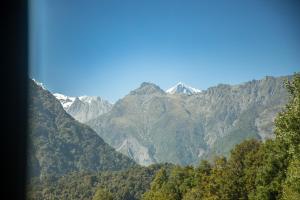 a view of a mountain range with trees and mountains at Ropatinis Bed & Breakfast in Fox Glacier