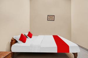 A bed or beds in a room at Hotel Om Residency
