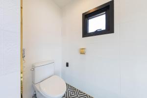 a bathroom with a toilet and a window at Private Pool Villa with filled with stars in Ulsan