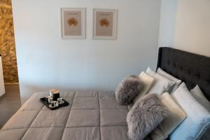 a bedroom with a bed with furry pillows on it at Triantos Guesthome Suite in Tripolis