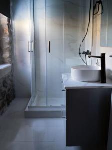 a bathroom with a sink and a shower at Triantos Guesthome Suite in Tripolis