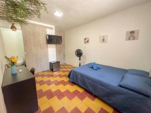 a bedroom with a blue bed and a table in it at Casa encanto, Apartamento - Habitaciones, Laureles-América in Medellín