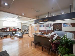 a store lobby with a large counter and aury officer sign at Hotel Yamanouchi in Naha