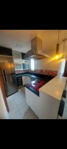 a kitchen with a white counter top and a stove at Condominio Dumont in Canoas