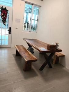 a wooden table and benches in a room at Xiaomi Courtyard B&B in Chishang
