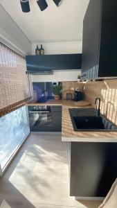 a kitchen with a sink and a counter top at T1 luxe à 2 minutes de la plage in Les Trois-Îlets