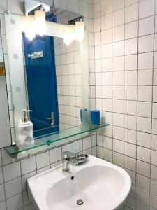 y baño con lavabo y espejo. en Appartement Bananasun, en Le Diamant