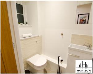 a white bathroom with a toilet and a sink at Central Durham - Luxury Hideout - Free Parking in Durham