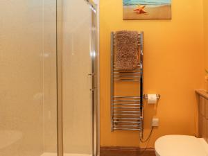a shower stall in a bathroom with a toilet at Marys House in Kilchoan +16 photos