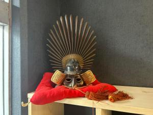a mask with a helmet on top of a table at Hostel JAQ takamatsu in Takamatsu